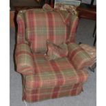 A loose covered Colefax & Fowler tartan armchair