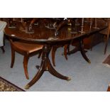 A Regency style mahogany twin-pedestal dining table, with additional leaf