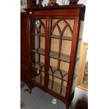 An Edwardian mahogany display cabinet with lancet arched glazed doors