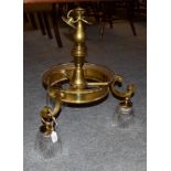 A brass three light electrolier with heavy slice cut glass shades