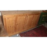 A large six-door pine cupboard, 292cm by 54cm by 100cm