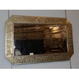 A brass Arts & Crafts style bevel mirror; together with an English school (19th/20th century)