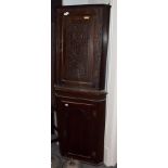 A George III carved oak corner cupboard; and a George III oak corner cupboard with panelled door (