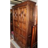 An early 20th century carved oak Jacobean style double-door wardrobe