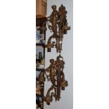 A pair of reproduction three-light figural wall sconces
