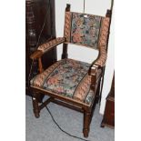 An early 20th century oak open armchair, in the 17th century style, by Waring & Gillows