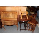 A 1930's figured walnut bureau; an early 20th century oak drop-leaf table; a nest of three tables;