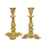 A Pair of French Gilt Bronze Candlesticks, in Rococo style, with acanthus leaf sheathed nozzles,