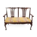 A Carved Mahogany Chippendale Style Two-Seater Chair Settee, the carved top rail and pierced