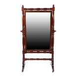 A Regency Carved Mahogany Cheval Mirror, early 19th century, the mirror plate within a pivoting