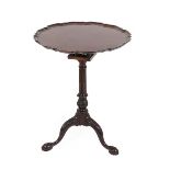 A George III Style Mahogany Tripod Table, the associated circular pie-crust top above a birdcage