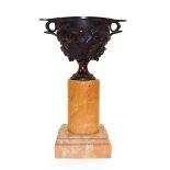 A Bronze Urn, after the Antique, the scroll handles cast with leafy fronds with berries, on a