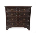 A 17th Century Oak Straight Front Chest of Drawers, the moulded top above four geometric moulded