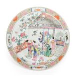 A Chinese Porcelain Charger, Yongzheng, painted in famille rose enamels with figures in a garden