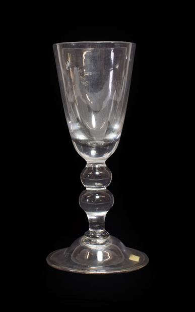 A Baluster Glass Goblet, possibly Lauenstein, mid 18th century, the rounded funnel bowl on a