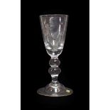 A Baluster Glass Goblet, possibly Lauenstein, mid 18th century, the rounded funnel bowl on a