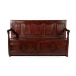 A George III Joined Oak Settle, late 18th century, the back support with five fielded panels above a