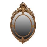 A French Gilt and Gesso Oval Mirror, circa 1870, the original mirror plate framed with a beaded