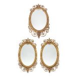 A Victorian Gilt and Gesso Oval Mirror, in Adam style, the oval bevelled glass plate within a