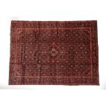 Hamadan Carpet West Iran, circa 1950 The tomato red Herati field centred by an indigo medallion