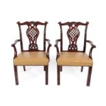 A Pair of Chippendale Revival Carved Mahogany Carver Chairs, late 19th century, covered in close-