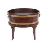 A George III Mahogany and Brass Bound Oval Wine Cooler, stamped Gillows, late 18th century, of