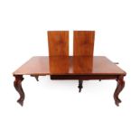 A Victorian Carved Mahogany Wind-Out Dining Table, circa 1870, the three original leaves and a