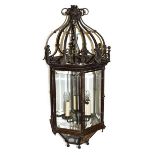 A Patinated Metal Hall Lantern, 19th century, of hexagonal form with scrollwork superstructure,