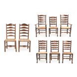 A Set of Six Mid 19th Century Ash and Rush-Seated Ladderback Chairs, including two carvers, the