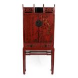 An 18th Century Chinese Red Lacquer Cabinet, the pierced trellis above two cupboard doors painted in