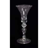 A Baluster Wine Glass, circa 1740, the bell shaped bowl on an annular knop and baluster stem with