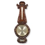 A Victorian Mahogany Carved Wheel Barometer, signed T.Pritchard, London, circa 1850, finely carved
