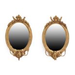 A Pair of Early Victorian Gilt and Gesso Oval Girandole Mirrors, mid 19th century, the moulded