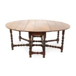 An Eight-to-Ten-Seater Oak Gateleg Dining Table, circa 1700, with two dropleaves to form an oval, on