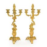 A Pair of Gilt Bronze Four-Light Figural Candelabra, in Louis XV style, with flammiform finial and