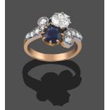 A Sapphire and Diamond Crossover Ring, the old cut diamond and round cut sapphire, in white claw