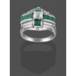 An Emerald and Diamond Cluster Ring, a cross motif formed of calibré cut emeralds with a central