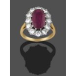 A Ruby and Diamond Cluster Ring, the central oval cut ruby within a border of round brilliant cut