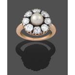 A Victorian Pearl and Diamond Cluster Ring, the pearl within a border of old cut diamonds in white