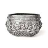 A Burmese Silver Bowl, Dated 1903, circular, the sides cast and chased in high relief with deities