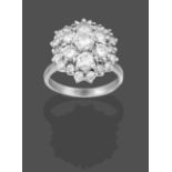 A Diamond Cluster Ring, the round brilliant cut diamond within two graduated stepped borders of