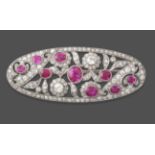 A Pink Sapphire and Diamond Brooch, circa 1925, the oval pierced plaque set throughout with oval cut