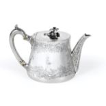 A Victorian Silver Teapot, by Robert Garrard, London, 1850, tapering and engraved with foliage,
