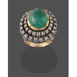 An Indian Emerald and Diamond Cluster Ring, the oval cabochon emerald in a yellow collet setting,