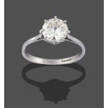 A Diamond Solitaire Ring, the round brilliant cut diamond in a white claw setting, to a tapered