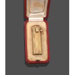 An 18 Carat Gold Lipstick Case, by Cartier, circa 1945, of cylindrical form with reeded