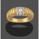 A Diamond Ring, a central cluster of round brilliant cut diamonds in yellow pavé settings, to a