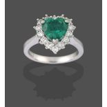 A Platinum Emerald and Diamond Cluster Ring, the heart shaped emerald within a border of round