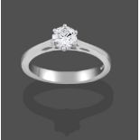 A Platinum Diamond Solitaire Ring, the round brilliant cut diamond in a claw setting, to a tapered