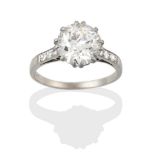 A Diamond Solitaire Ring, the round brilliant cut diamond in a claw setting, to tapered eight-cut